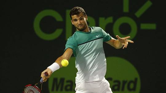 Mar 29, 2016; Key Biscayne, FL, USA; Grigor Dimitrov hits a forehand against Gael Monfils (not pictured) during day nine of the Miami Open at Crandon Park Tennis Center. Monfils won 6-7(5), 6-3, 6-3. Mandatory Credit: Geoff Burke-USA TODAY Sports